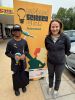Photo of Professor Kerrie Wilson with a student in front of a Science Week pull-up sign for National Science Week 2025