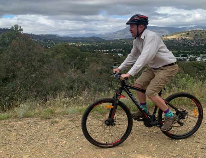 Professor Hugh Possingham riding his bike.